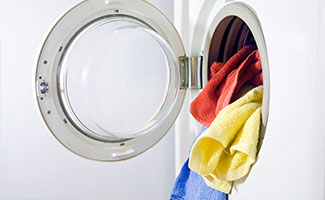 energy efficient clothes washer with colorful towels spilling out